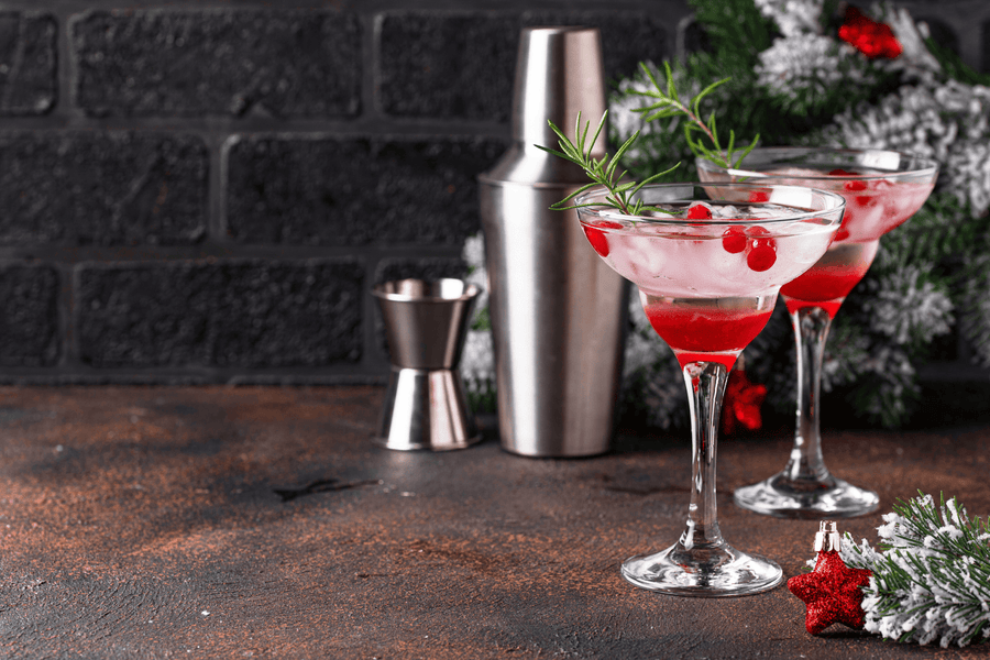 Christmas red holiday cocktails with cranberries and rosemary garnish