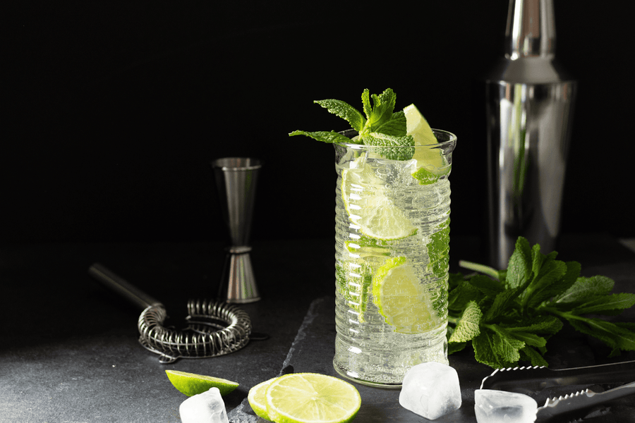 Refreshing lime and mint cocktail in a tall glass with ice
