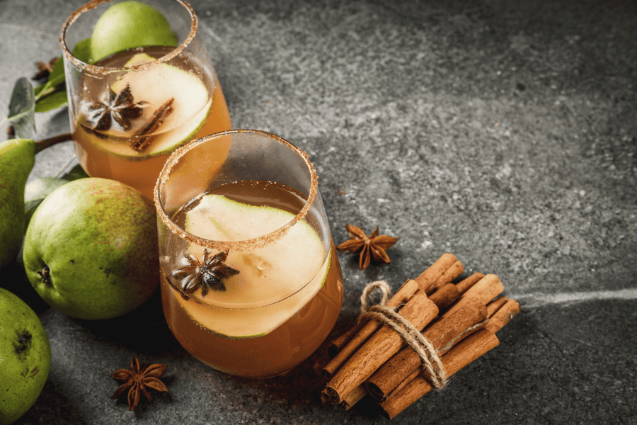 Autumn pear cocktail with cinnamon sticks, star anise, and fresh pears.